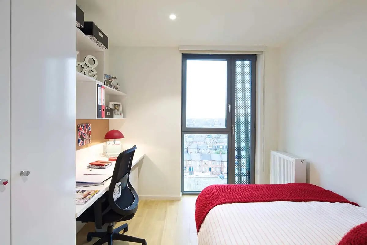 Bed desk shelves and window bedroom at Wood Lane Studios in London Student Accommodation