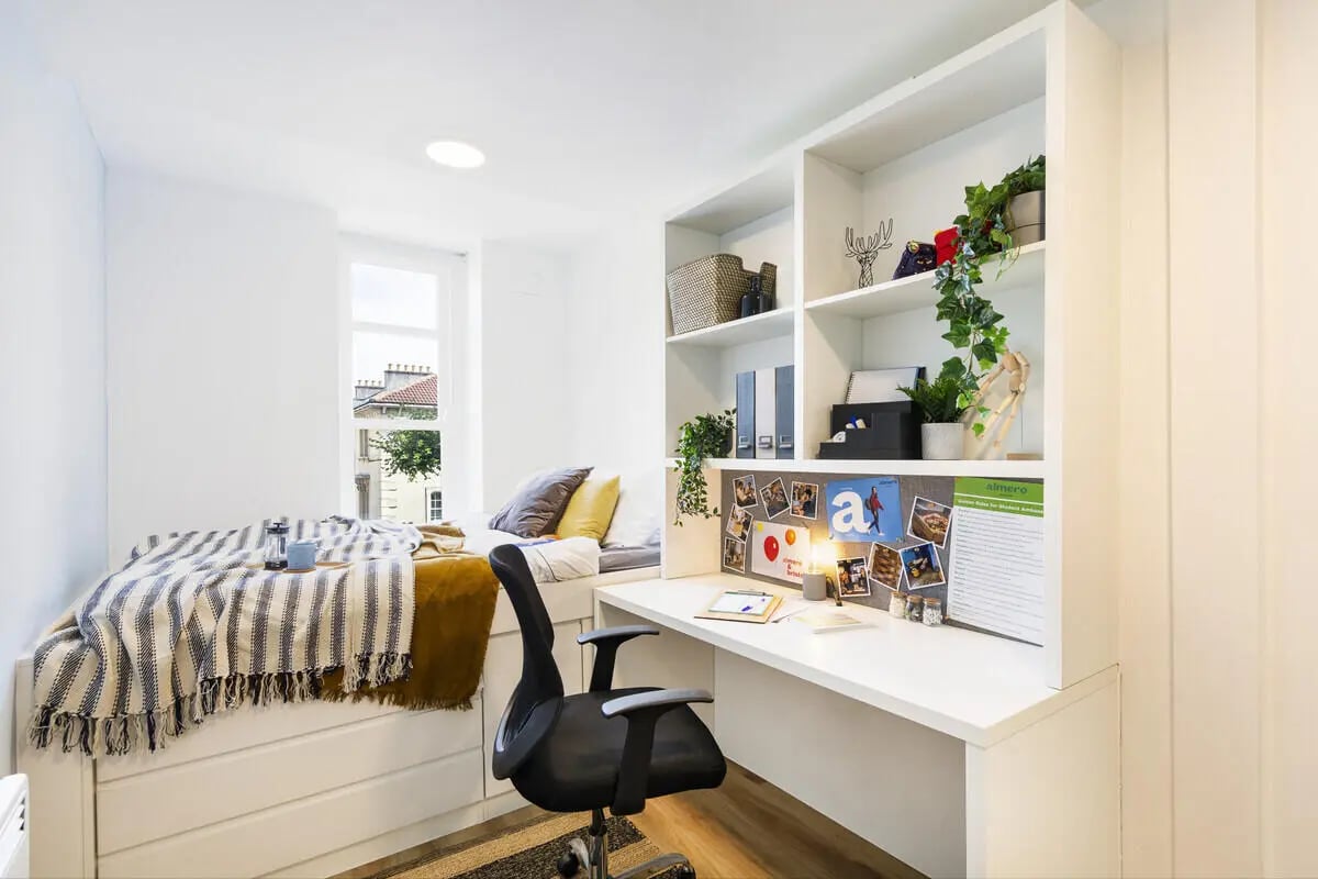 Bed desk chair shelves and window Bedroom at Tamarillo House in Bristol Student Accommodation