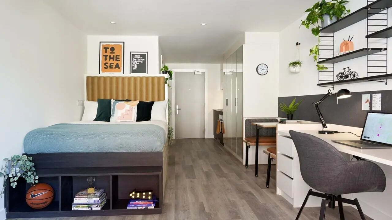 Bed desk and kitchenette student studio apartment at Student Castle Brighton in Brighton Student Accommodation