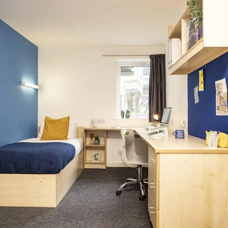 Bed desk chair and shelves bedroom study area at Albert Court in Liverpool Student Accommodation