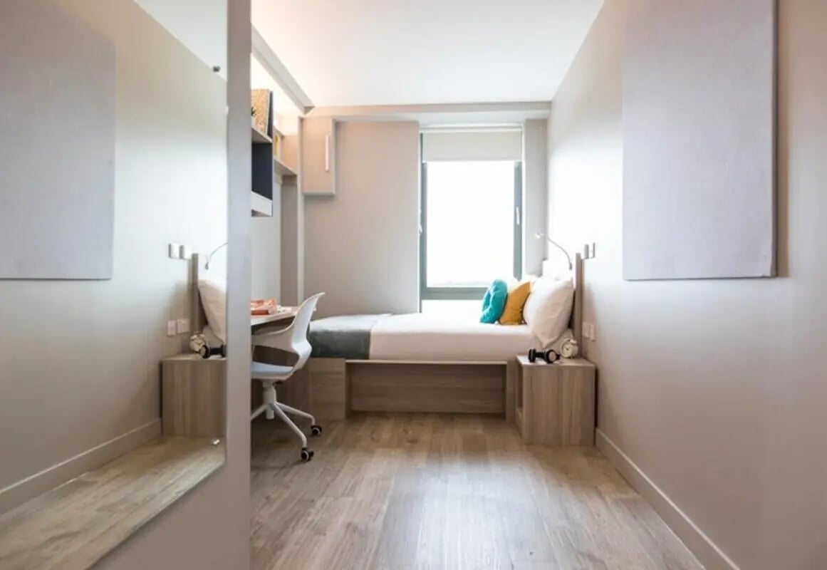 Bed desk chair pillows nightstand bedroom at Caton Court in Lancaster Student Accommodation