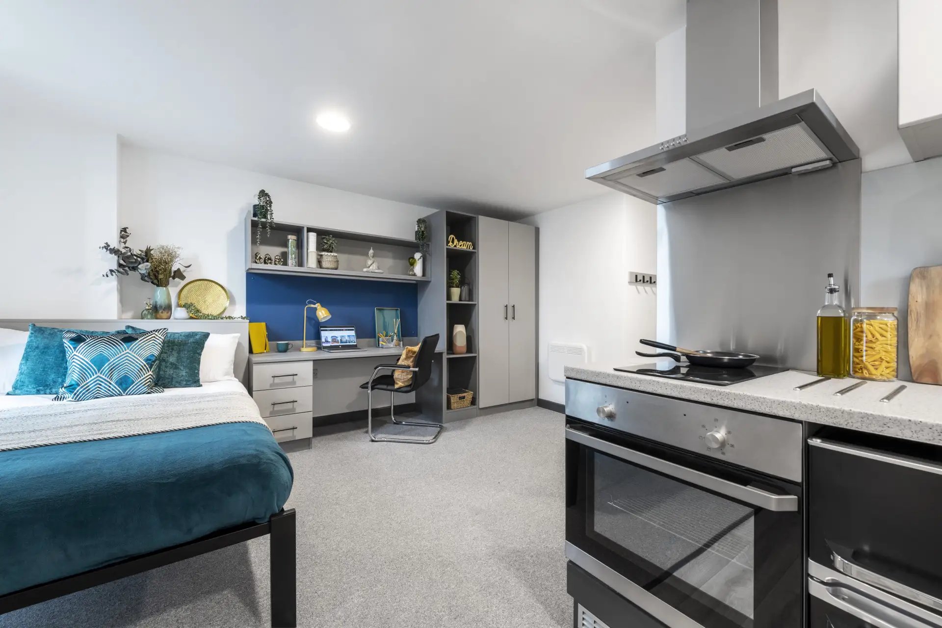 Bed desk chair and kitchen area studio at Compass in Birmingham Student Accommodation