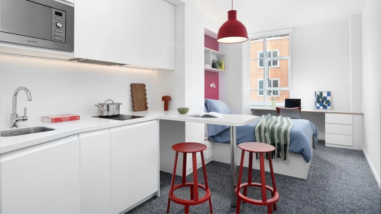 Kitchenette sink bed desk stools study area bedroom at Scape Bloomsbury in London Student Accommodation