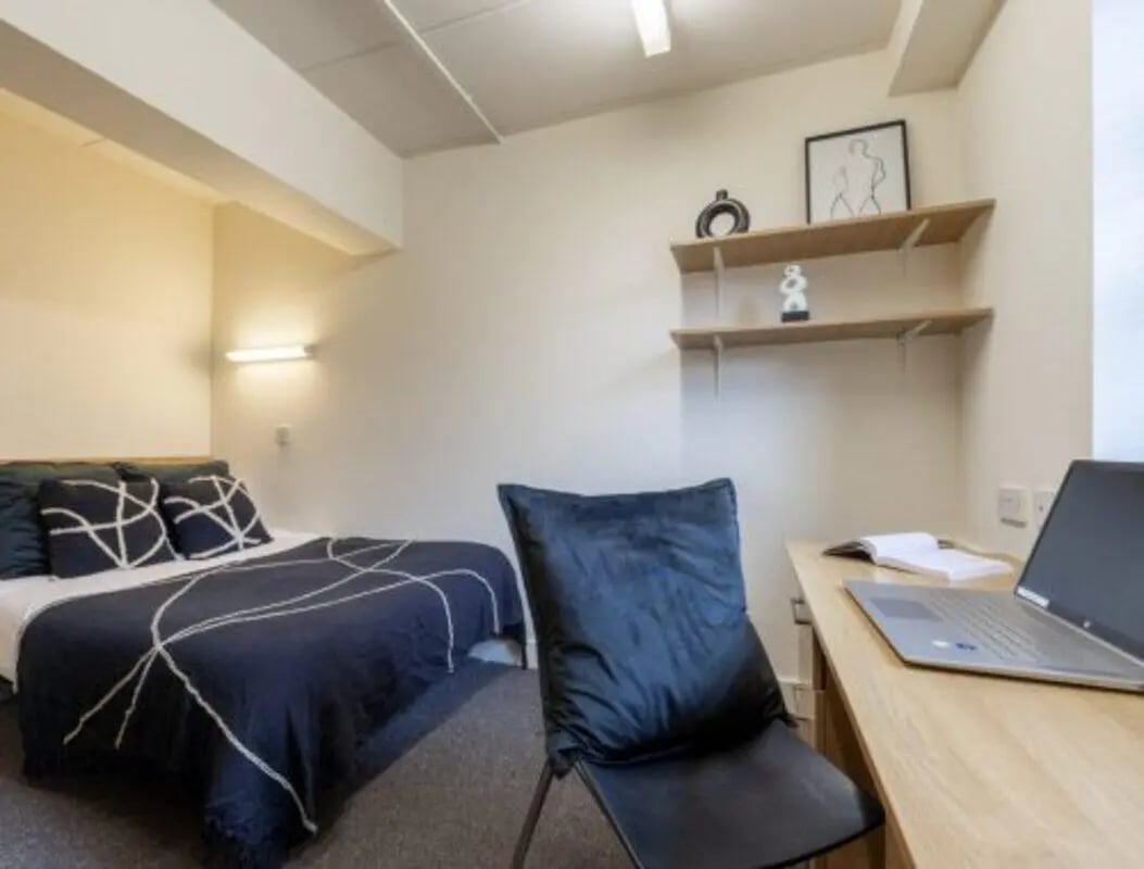 Bed laptop desk shelves and chair bedroom at Manchester Student Village in Manchester Student Accommodation