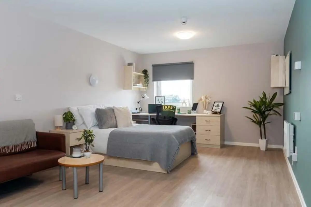 Bed sofa desk and chair bedroom study area at North Court in Cardiff Student Accommodation