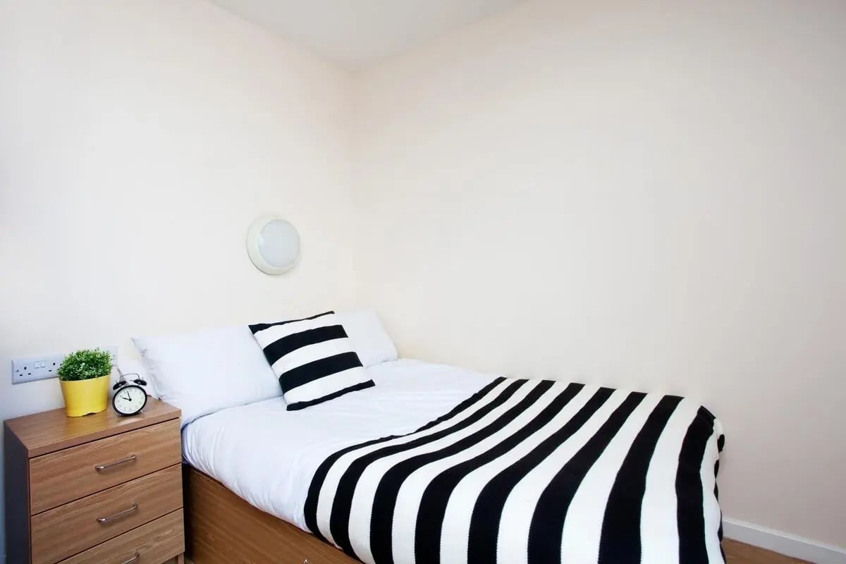 Bed dresser plant clock bedroom at Jennens Court in Birmingham Student Accommodation