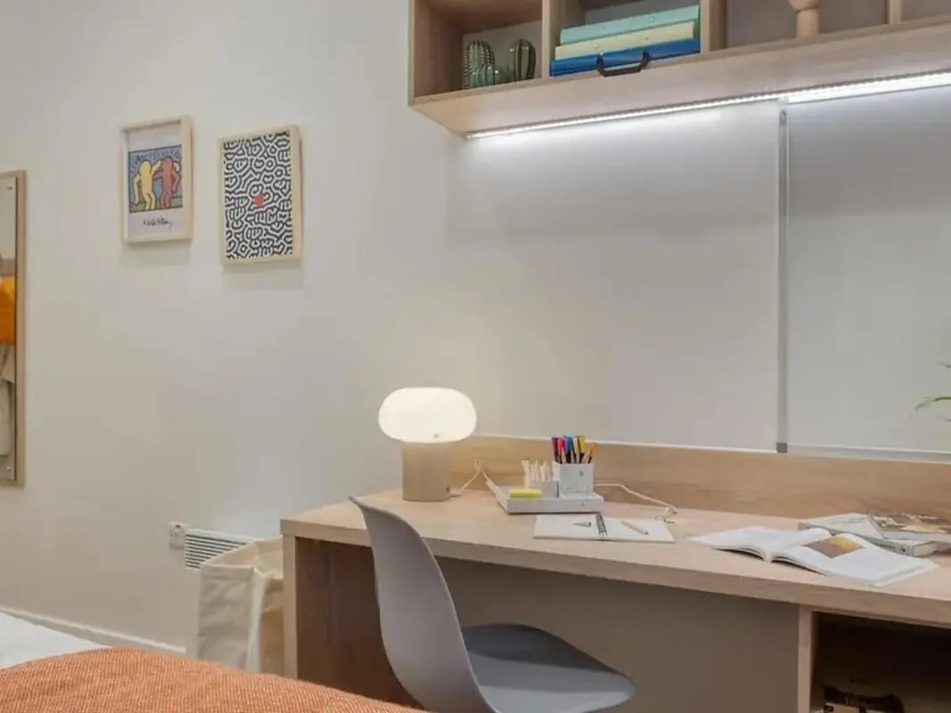 Desk with lamp books and chair study area at Yugo Beckley Point in Plymouth Student Accommodation