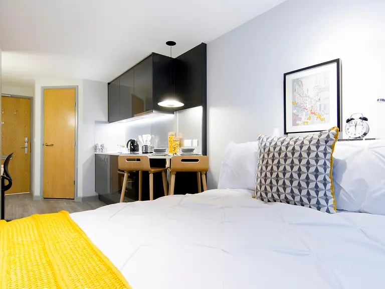 Bed kitchen counter with stools study area at Yugo Therese House in London Student Accommodation