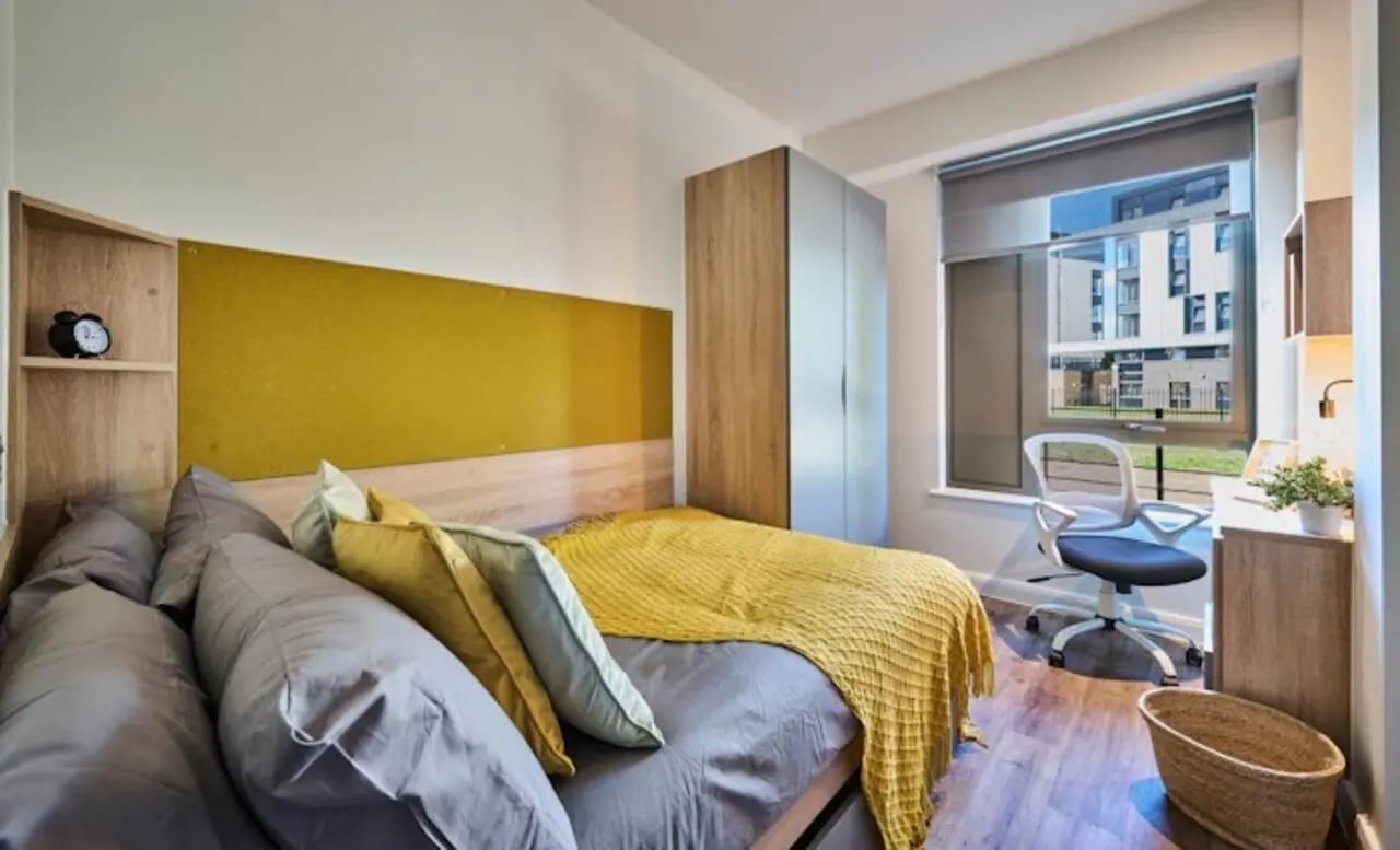 Bed wardrobe desk chair window bedroom at Deakins Place in Nottingham Student Accommodation