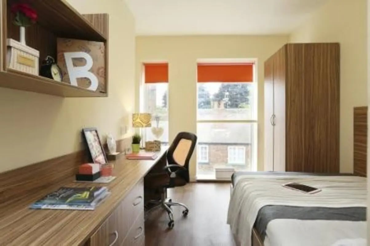 Desk chair wardrobe bed and shelves bedroom at Trinity Hall in Chester Student Accommodation