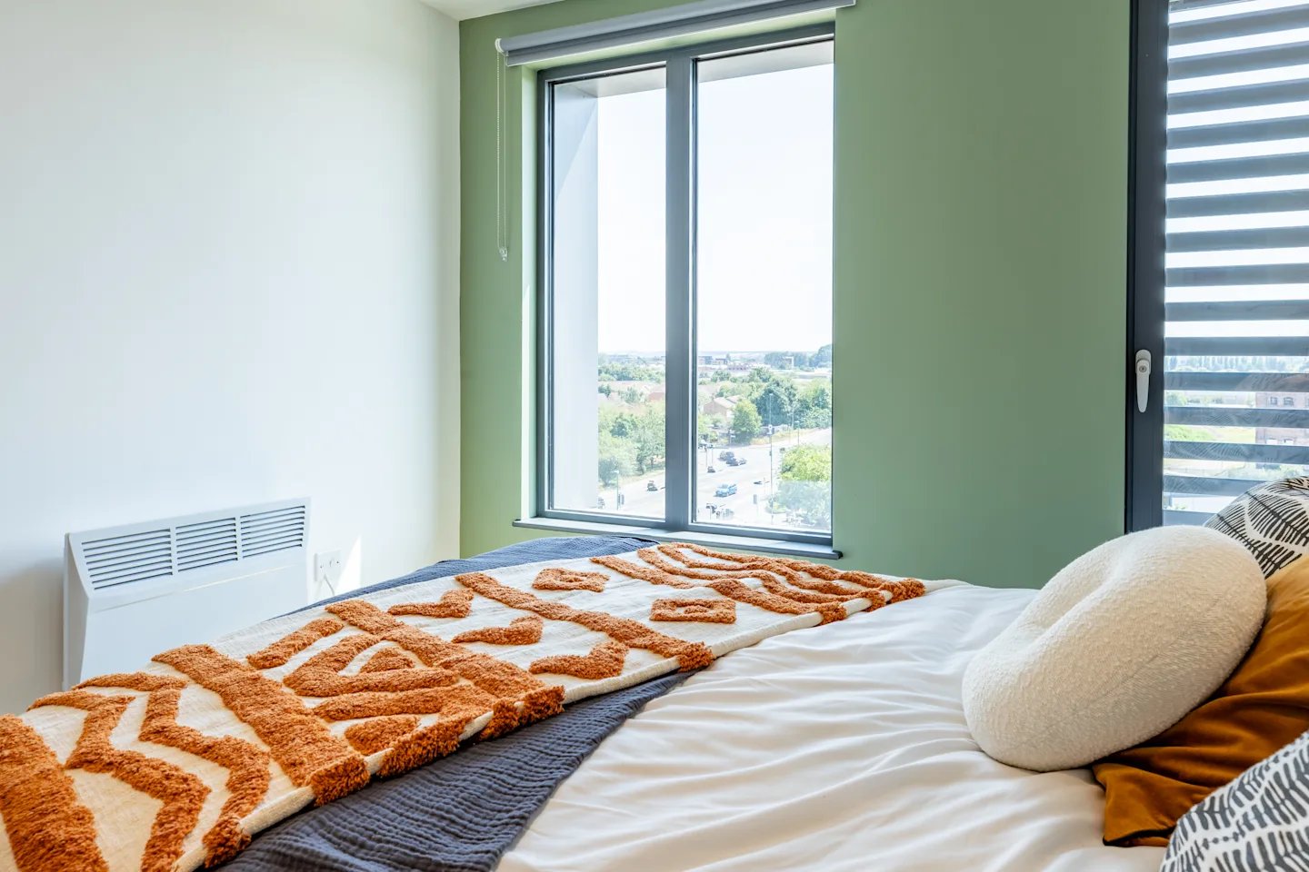 Bed with patterned throw heater and window bedroom at Winfield Court in Nottingham Student Accommodation