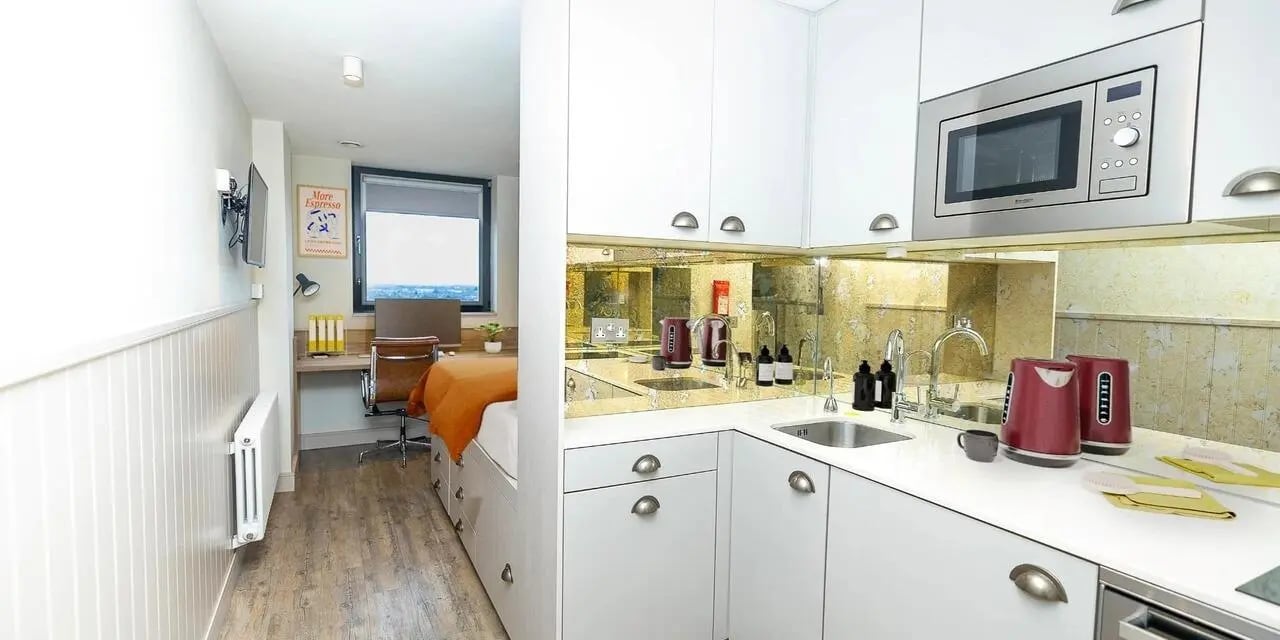 Bed desk and kitchen unit kitchen at Canvas The Parade in Cardiff Student Accommodation