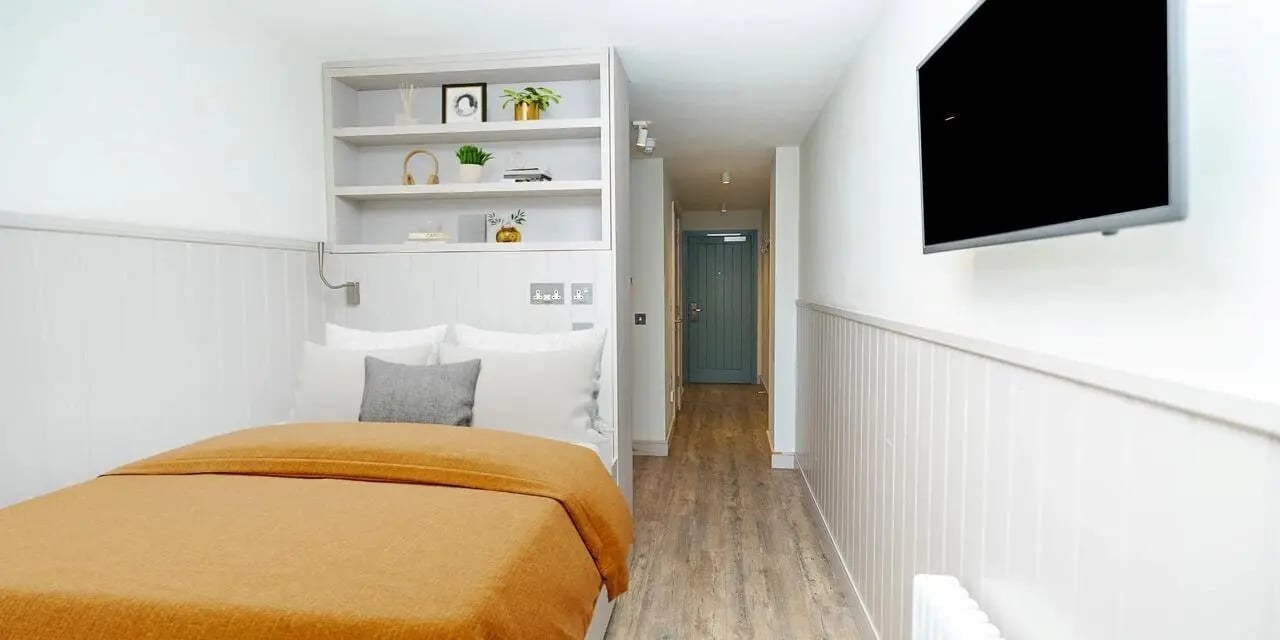 Bed with shelves and TV bedroom at Canvas The Parade in Cardiff Student Accommodation