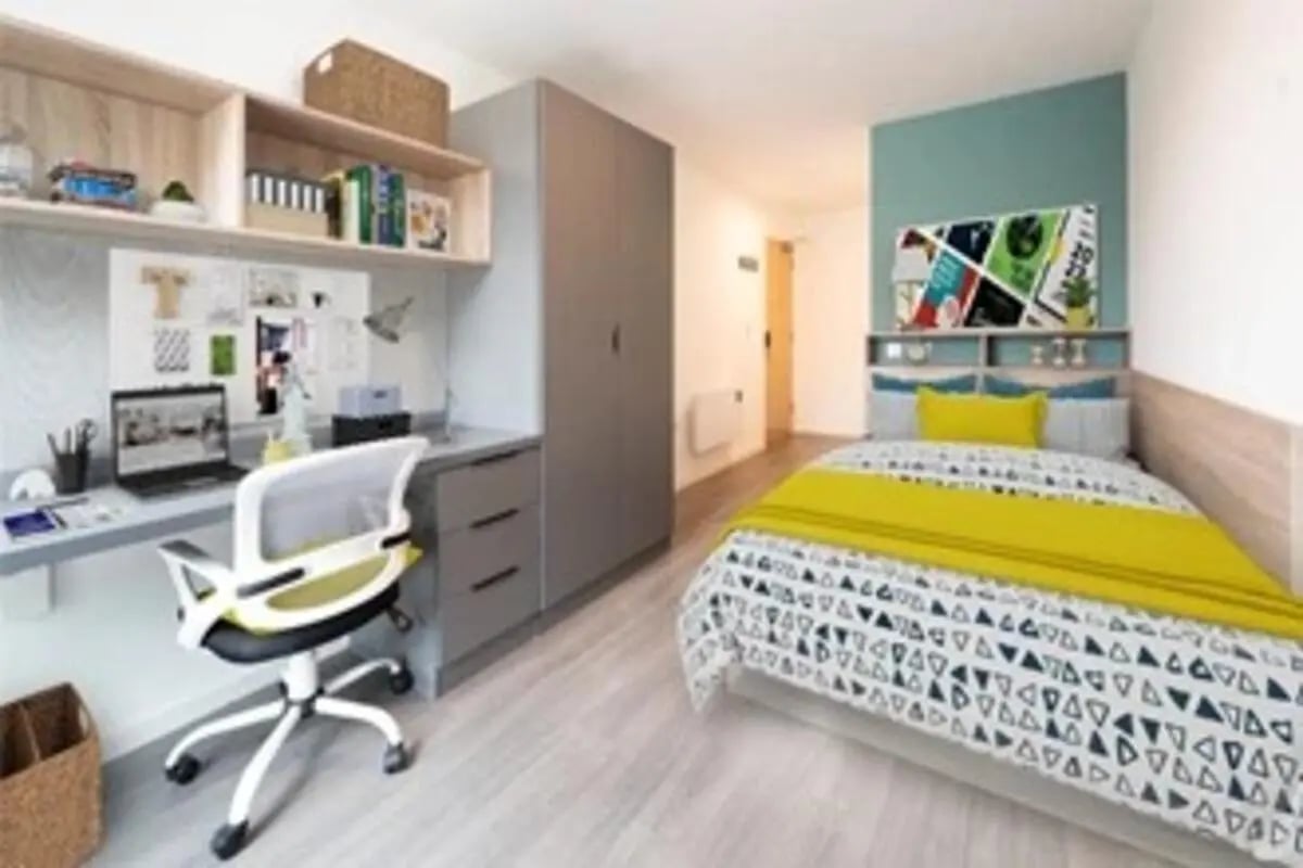 Desk chair wardrobe bed with yellow bedding bedroom at Canvas Bristol in Bristol Student Accommodation