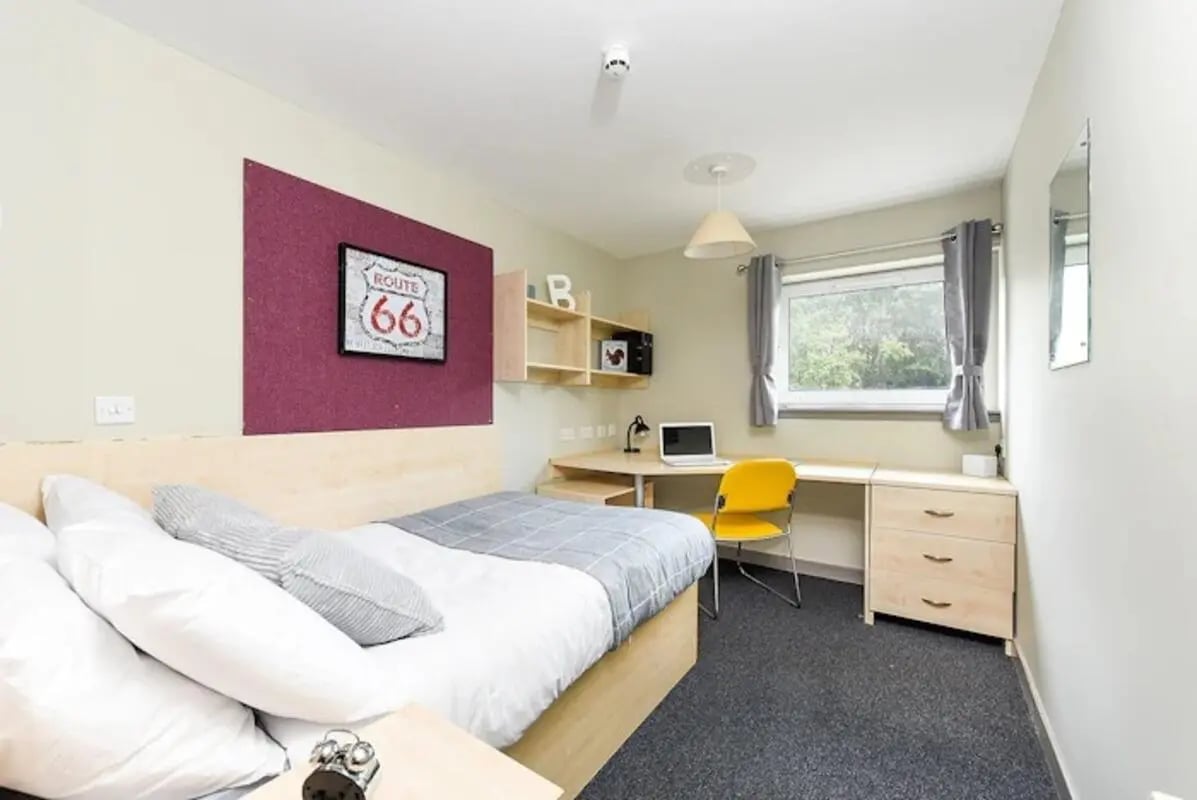 Bed desk microwave and yellow chair bedroom at Mealmarket Exchange in Aberdeen Student Accommodation