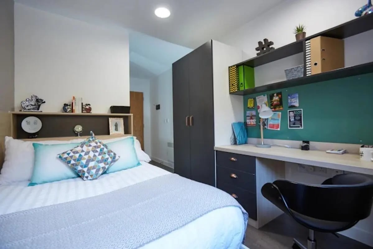 Bed wardrobe desk chair bedroom study area at Mannequin House in London Student Accommodation
