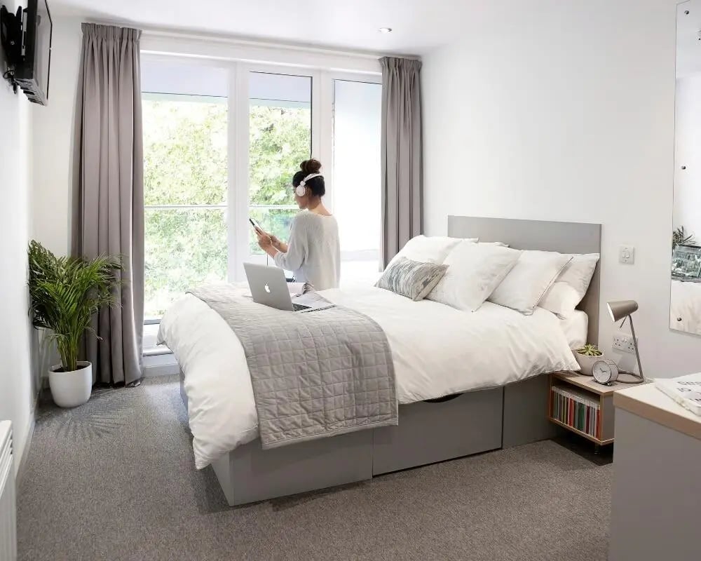 Bed laptop plant and window bedroom at Lace Market Studios in Nottingham Student Accommodation