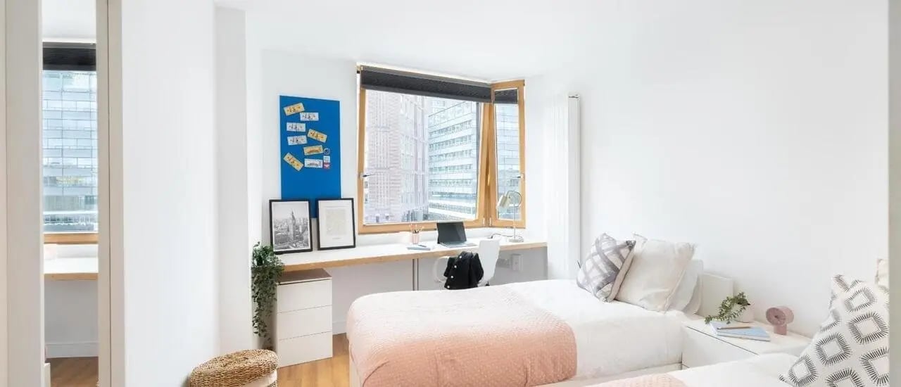 Two beds desk and city view bedroom at Chapter Aldgate in London Student Accommodation