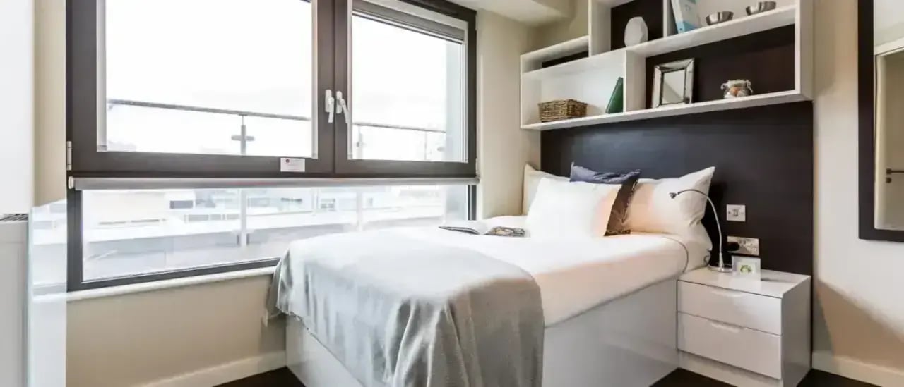 Bed bedside table shelves window bedroom at Chapter Old Street in London Student Accommodation