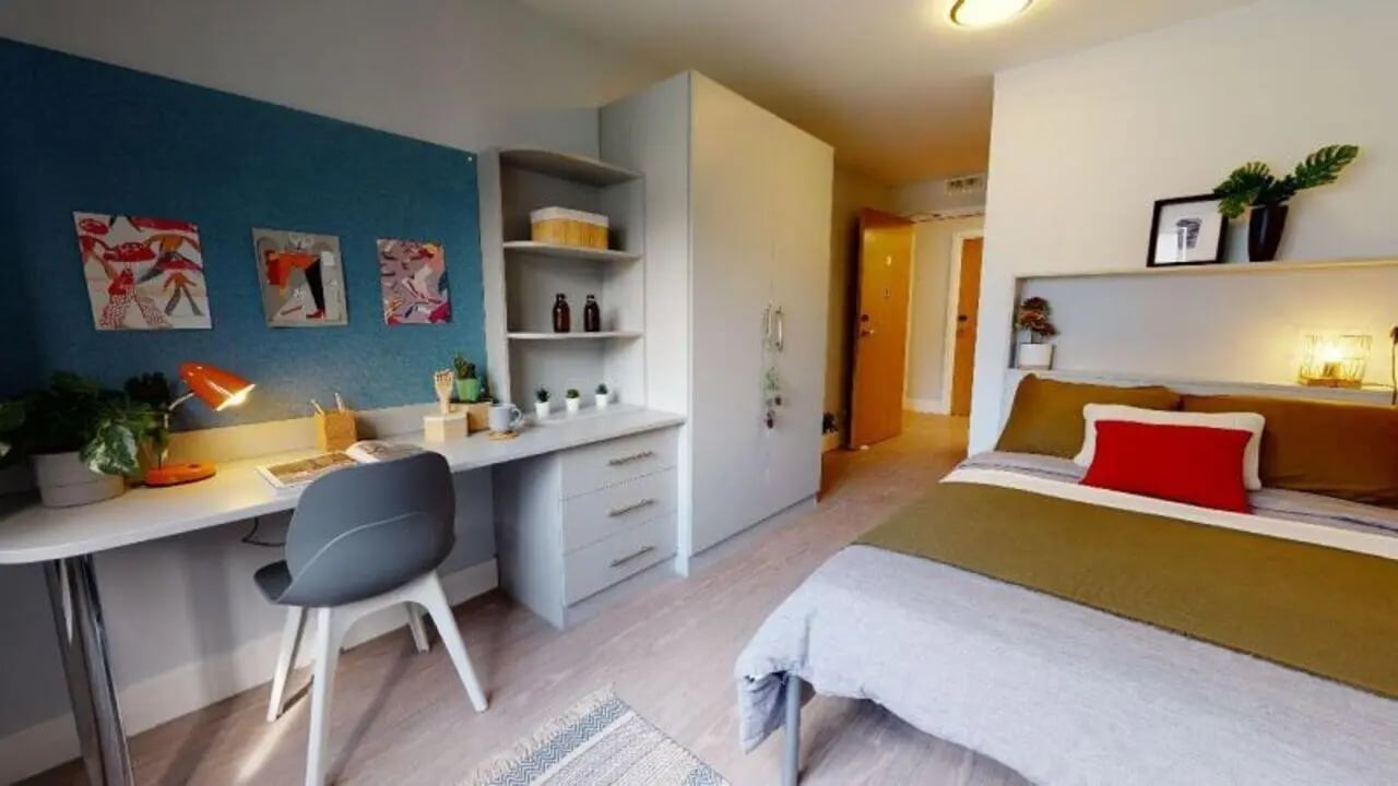 Desk bed wardrobe and door Bedroom at iQ Hoxton in London Student Accommodation