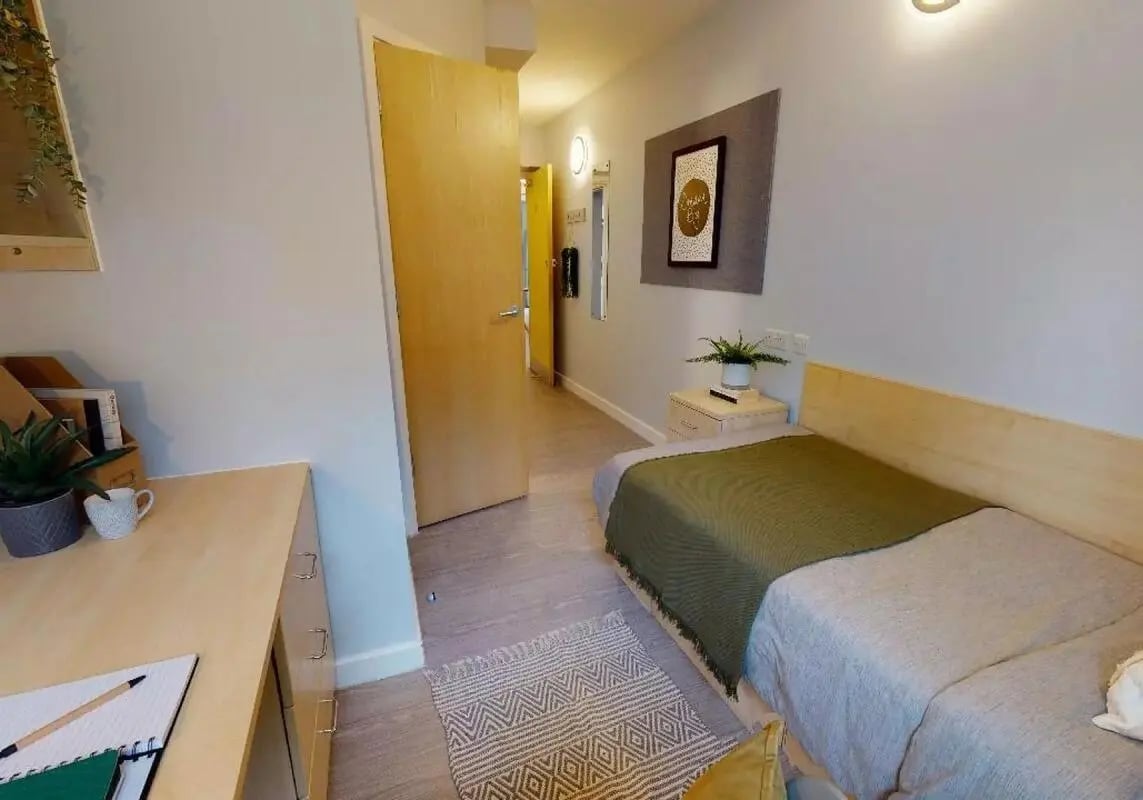Bed desk rug and nightstand bedroom at iQ Student Quarter in Salford Student Accommodation