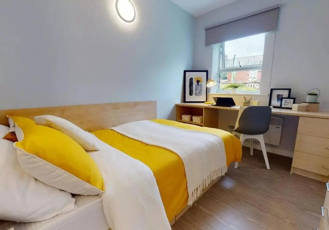 Bed desk chair laptop and wall lamp bedroom at iQ Student Quarter in Salford Student Accommodation