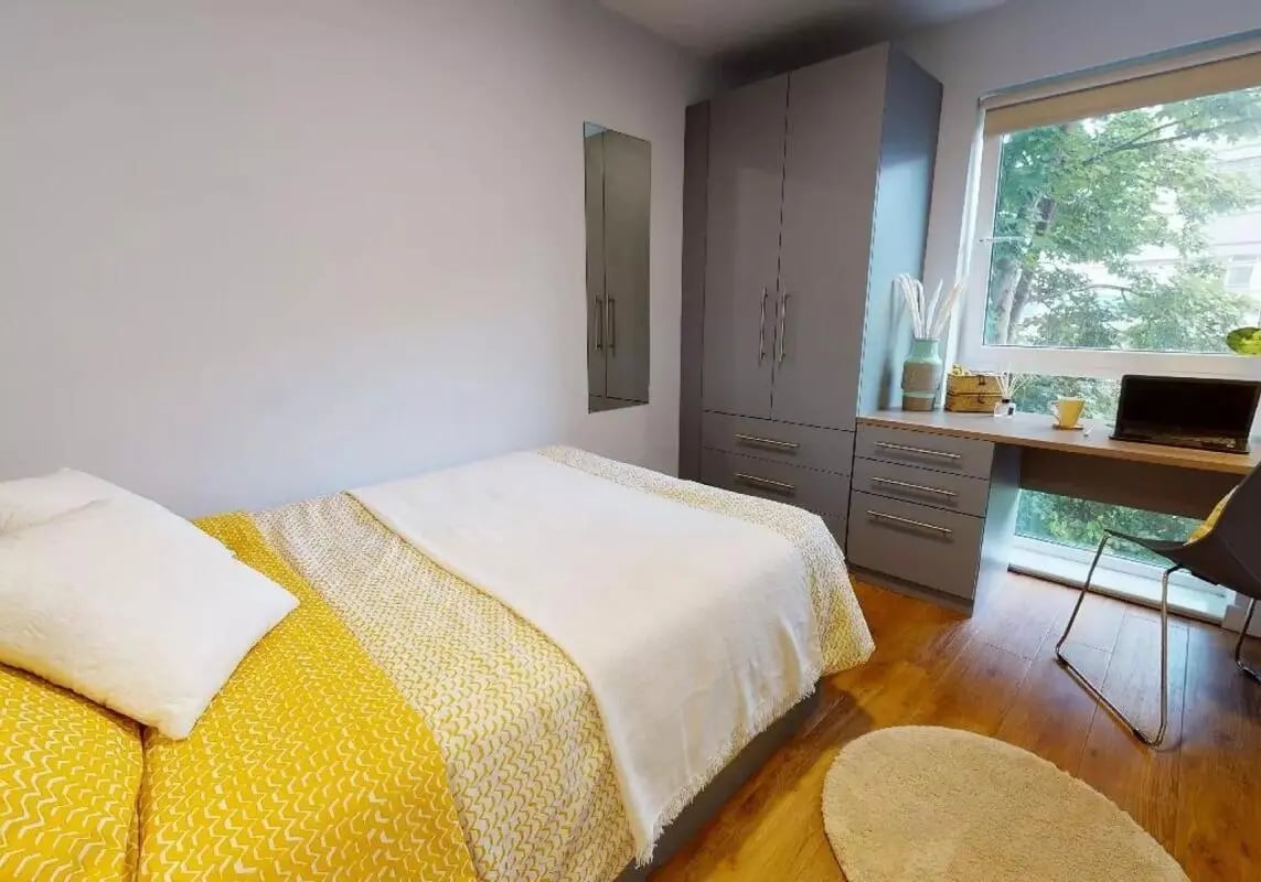 Bed wardrobe desk with laptop and chair bedroom at iQ Collingwood in Newcastle Upon Tyne Student Accommodation