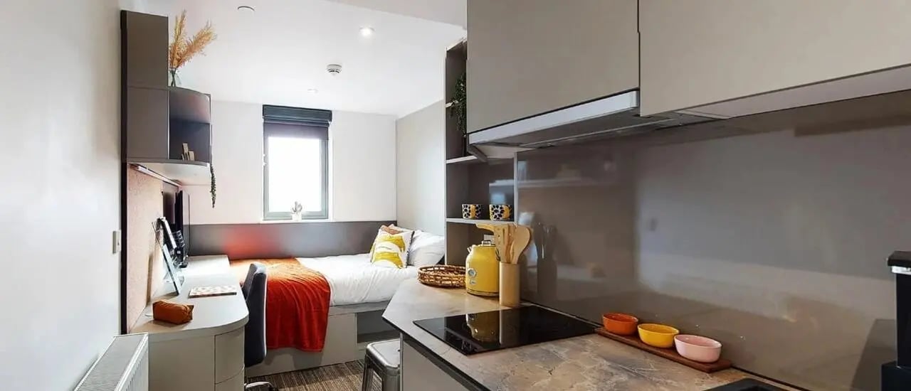 Bed desk and kitchen area student studio at Chapter Ealing in London Student Accommodation