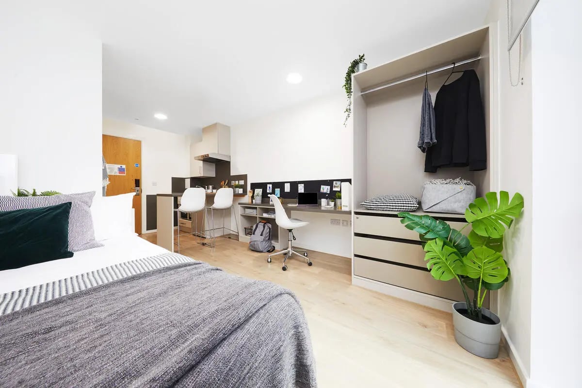 Bed kitchen desk closet plant studio apartment at Collegiate Bagot Street in Birmingham Student Accommodation