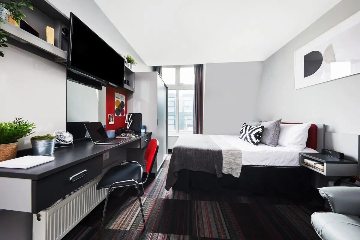 Bed desk TV and chair bedroom at Pillar Box in Coventry Student Accommodation
