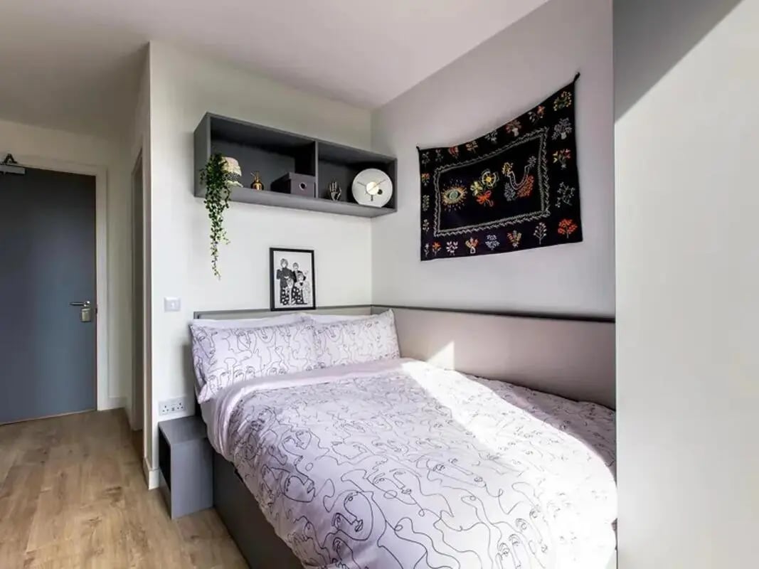 Bed with patterned bedding and wall art Bedroom at Lee Point in Cork Student Accommodation
