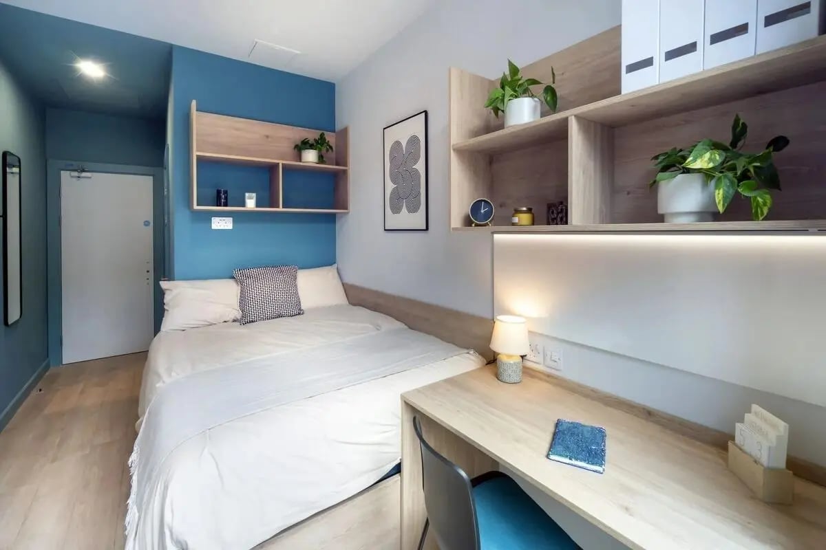 Bed desk plants shelves and door bedroom study area at Stoneybatter Place in Dublin Student Accommodation