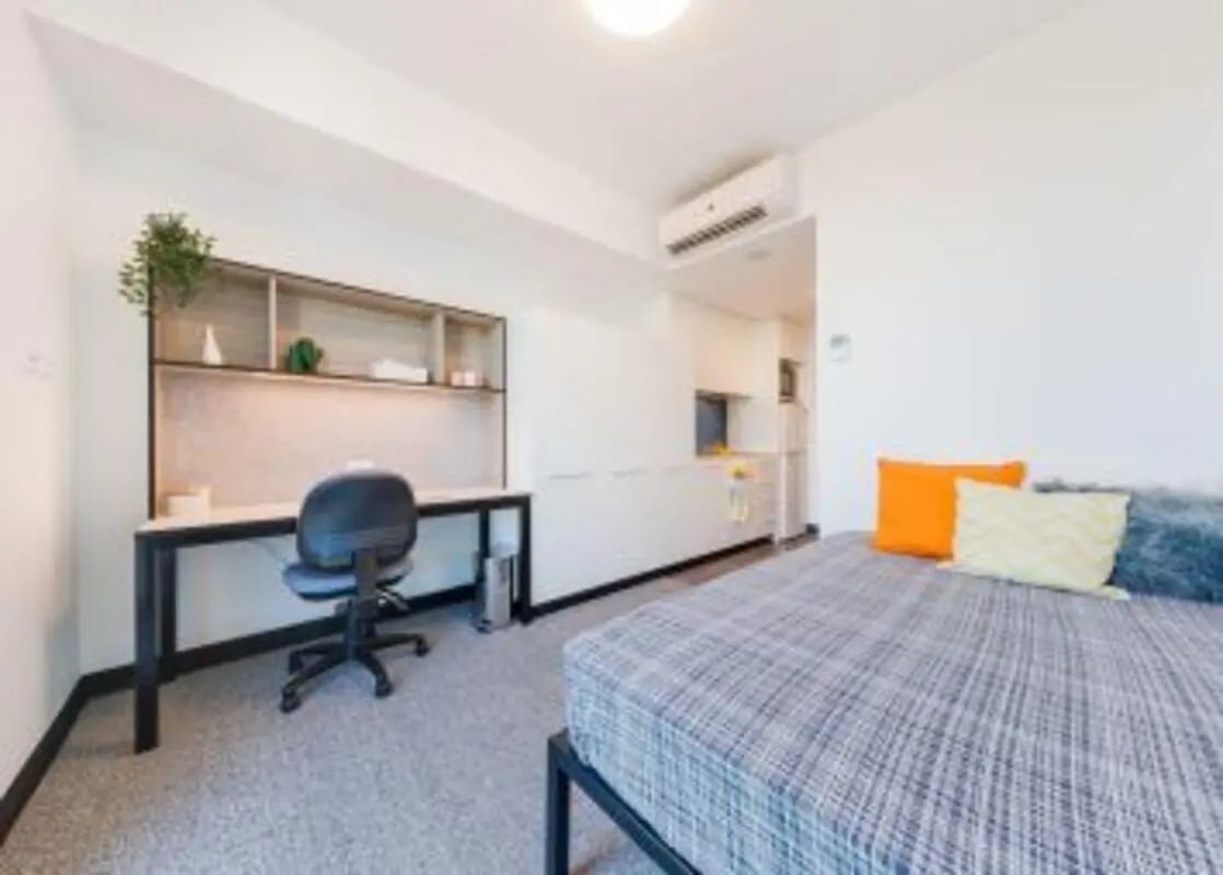 Desk chair shelves bed pillows student room at UniLodge Park Central in Brisbane Student Accommodation