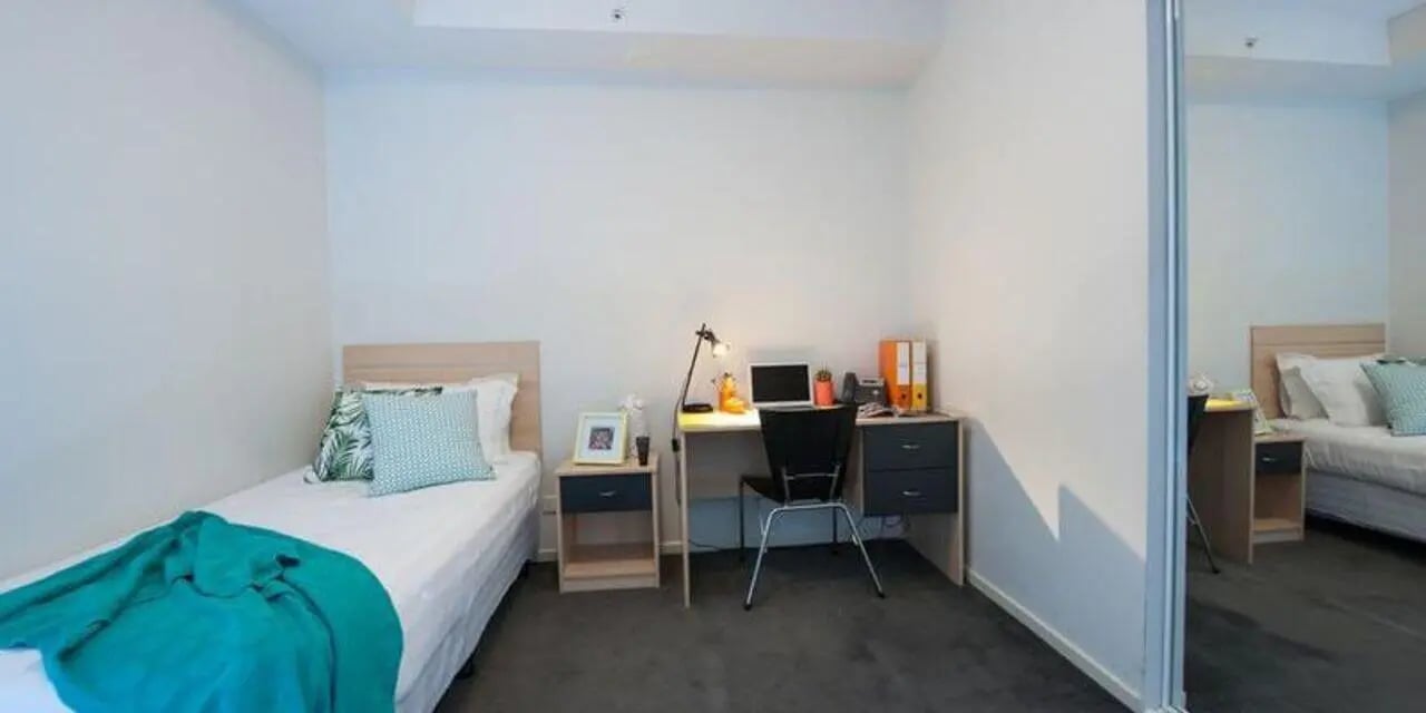 Bed desk lamp laptop chair study bedroom at Student Living on Lonsdale in Melbourne Student Accommodation