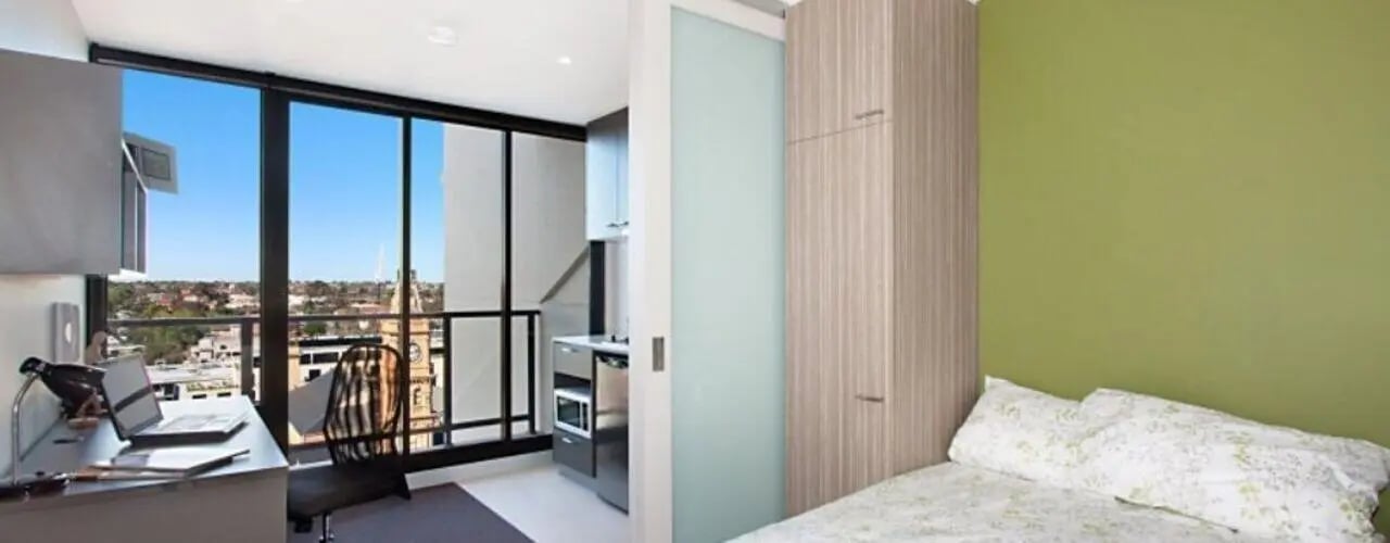 Desk laptop chair kitchen bed bedroom interior at Student Living - Vivida in Melbourne Student Accommodation