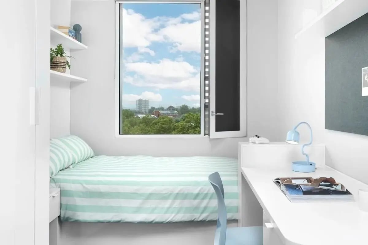 Bed desk chair and window bedroom study area at Scape Canada Water in London Student Accommodation