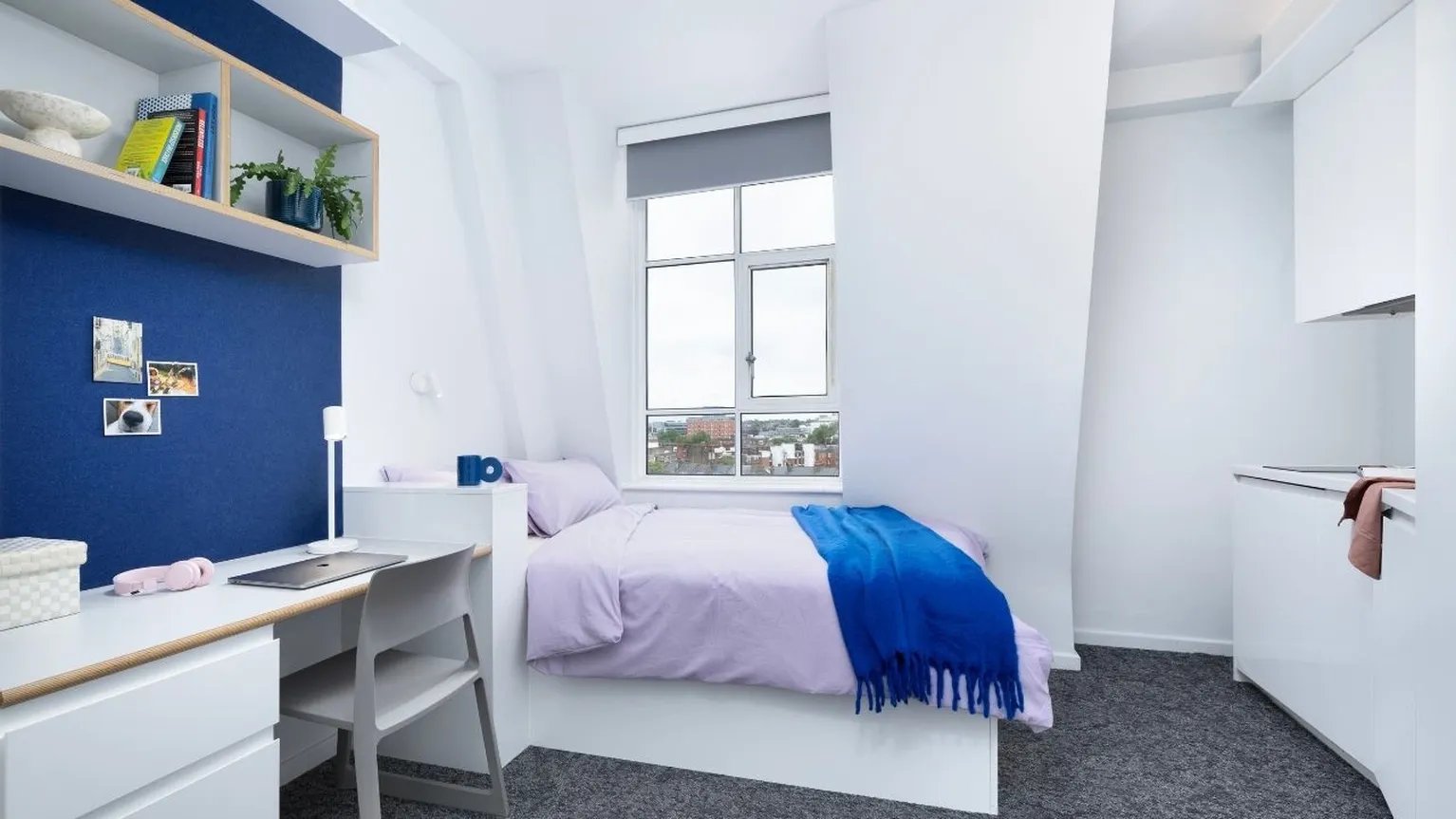 Bed desk shelves and kitchen area bedroom at Scape Bloomsbury in London Student Accommodation