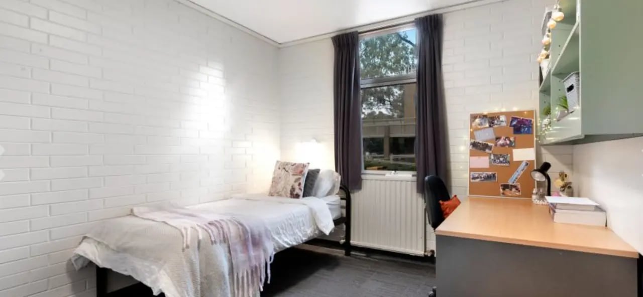 Bed desk and corkboard student bedroom at La Trobe University - Glenn College in Melbourne Student Accommodation