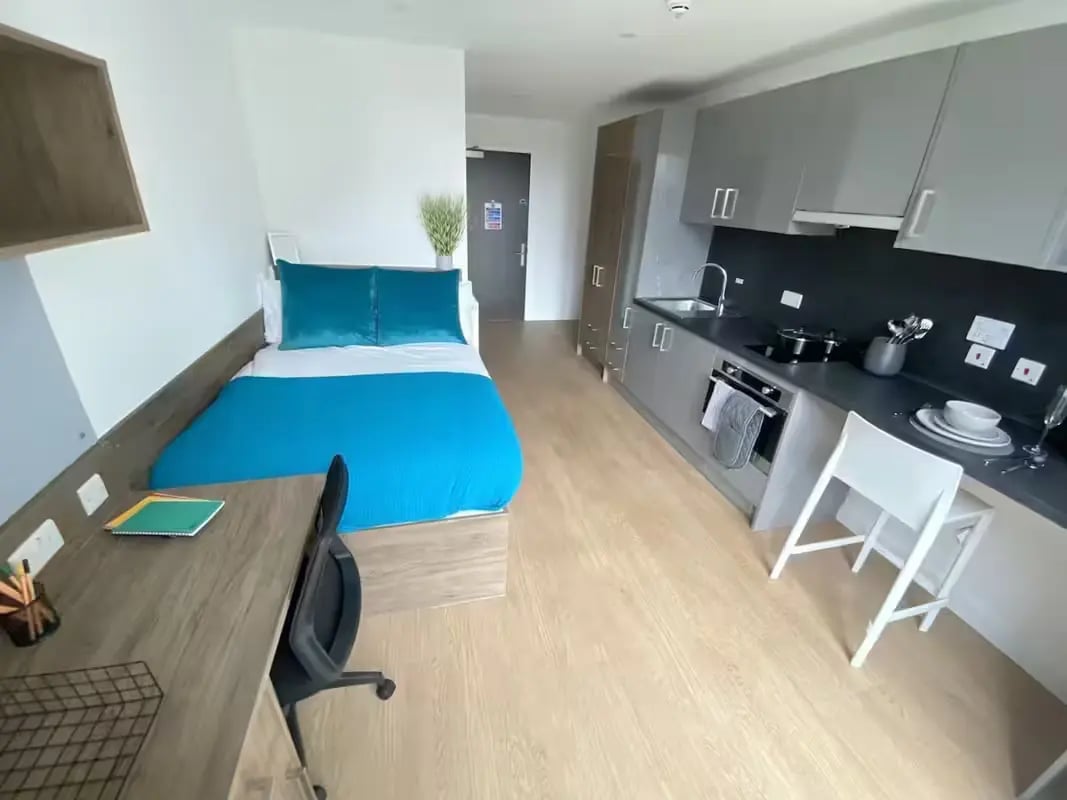 Bed desk kitchen and storage area studio at The Oaks in Coventry Student Accommodation