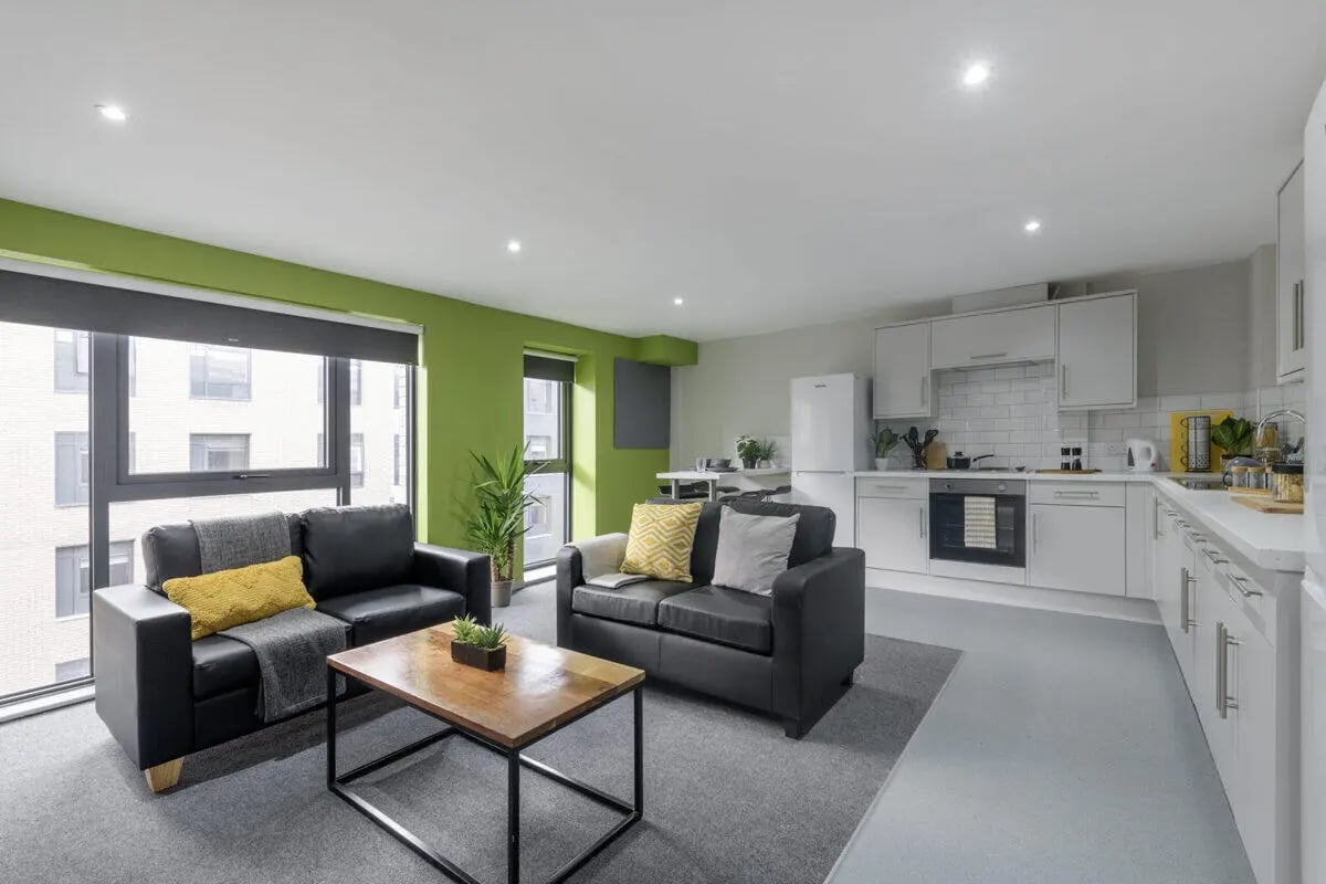 Two sofas coffee table kitchen living room at Bryson Court in Newcastle Upon Tyne Student Accommodation