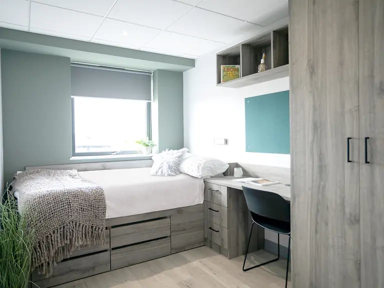 Bed desk closet with books study area bedroom at Crown Place Swansea in Swansea Student Accommodation