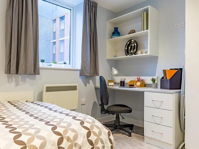 Bed desk shelving heater and chair bedroom at Mary Parker House in Plymouth Student Accommodation