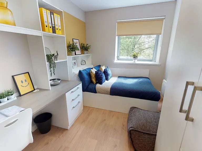 Bed desk shelves with binders and a smiley picture bedroom at Centro House in Stirling Student Accommodation