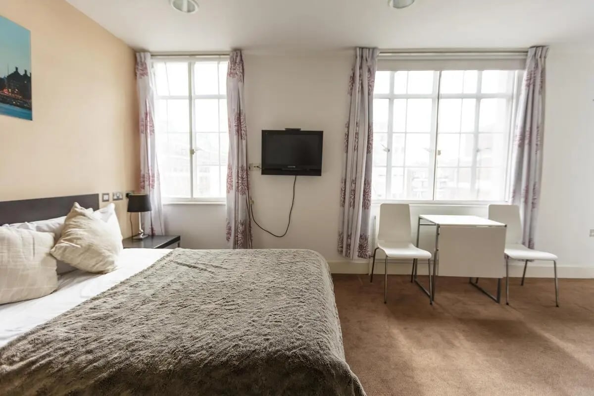 Bed TV table and chairs Bedroom at AXO Oxford Circus in London Student Accommodation