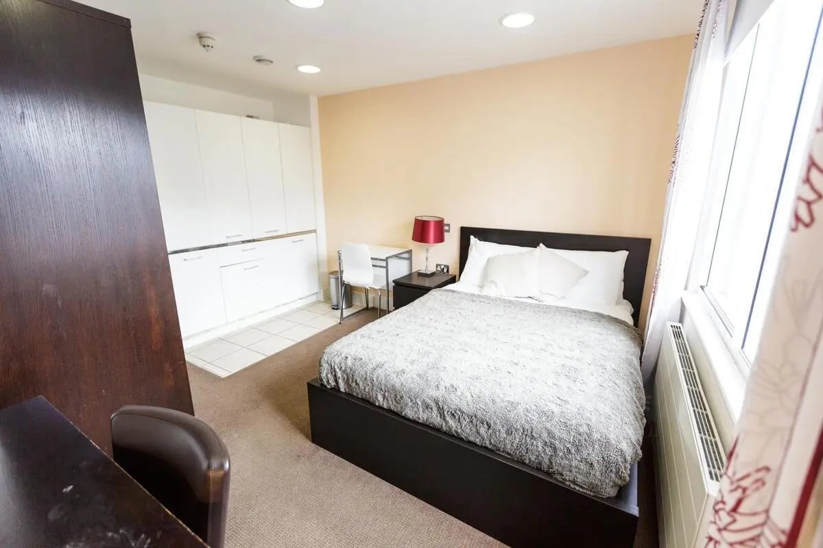 Bed desk cabinets white chairs bedroom at AXO Oxford Circus in London Student Accommodation