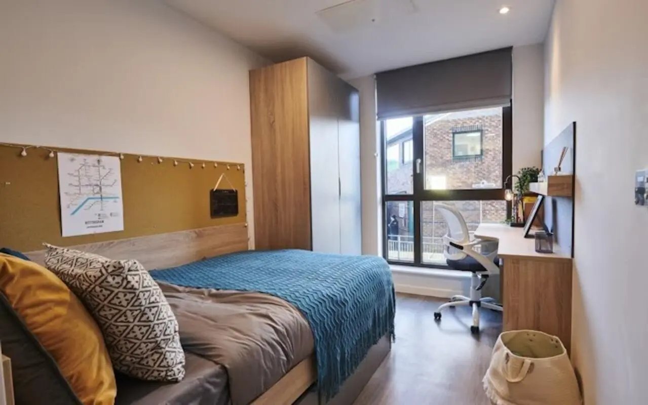 Bed wardrobe desk chair and basket bedroom at York House in Nottingham Student Accommodation