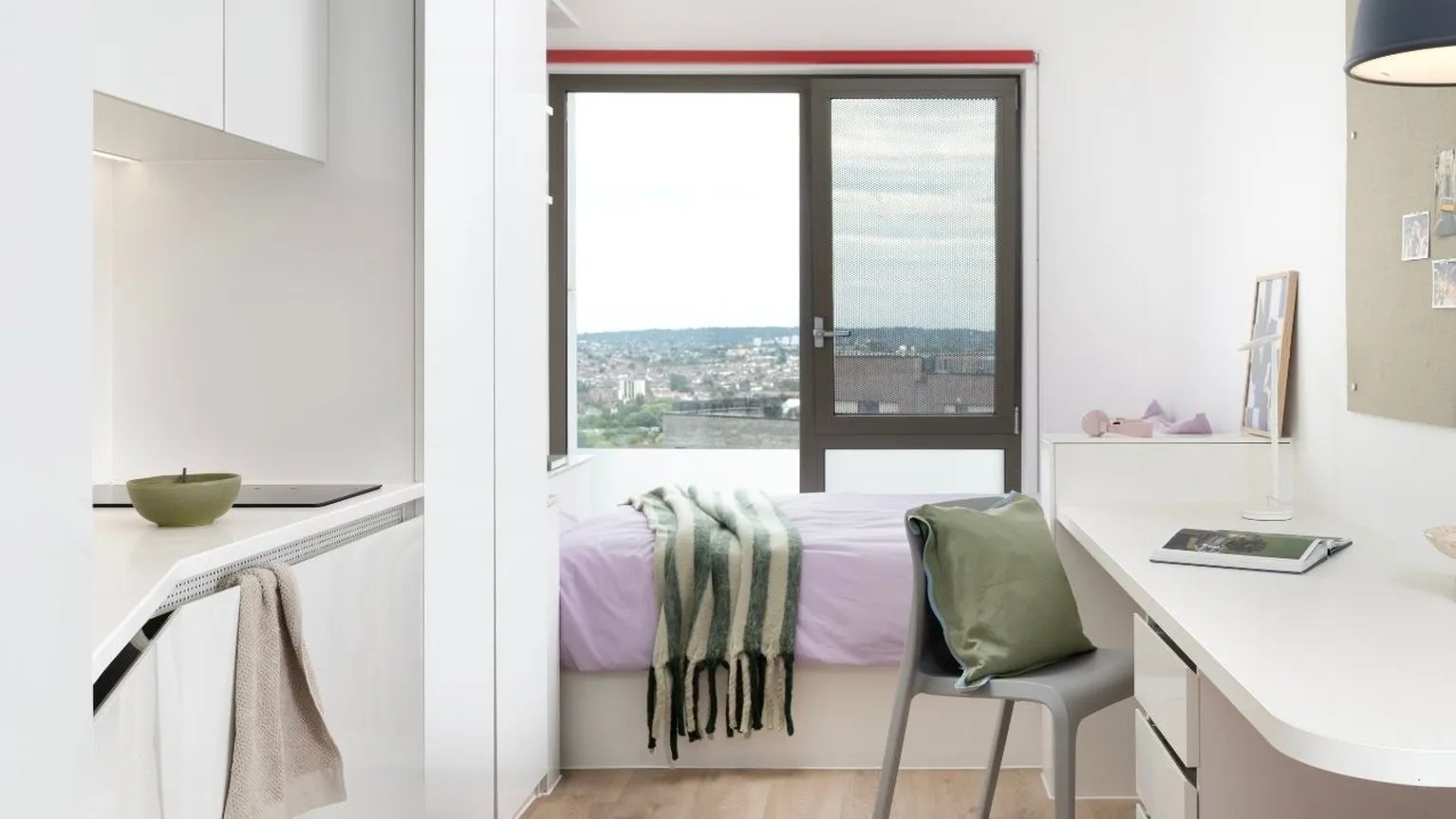 Bed desk kitchen with city view bedroom at Scape Wembley in London Student Accommodation