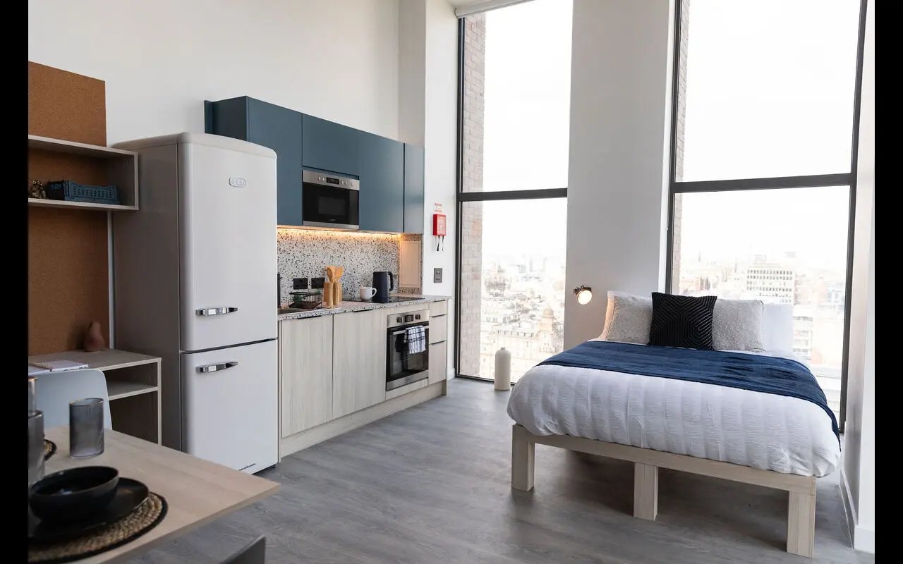 Studio apartment with bed kitchen and windows bedroom at Martha Street Apartments in Glasgow Student Accommodation