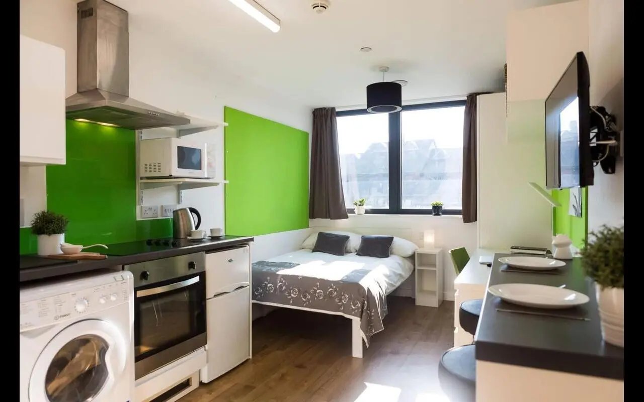 Kitchenette bed desk and television bedroom at St Lawrence House in Bristol Student Accommodation
