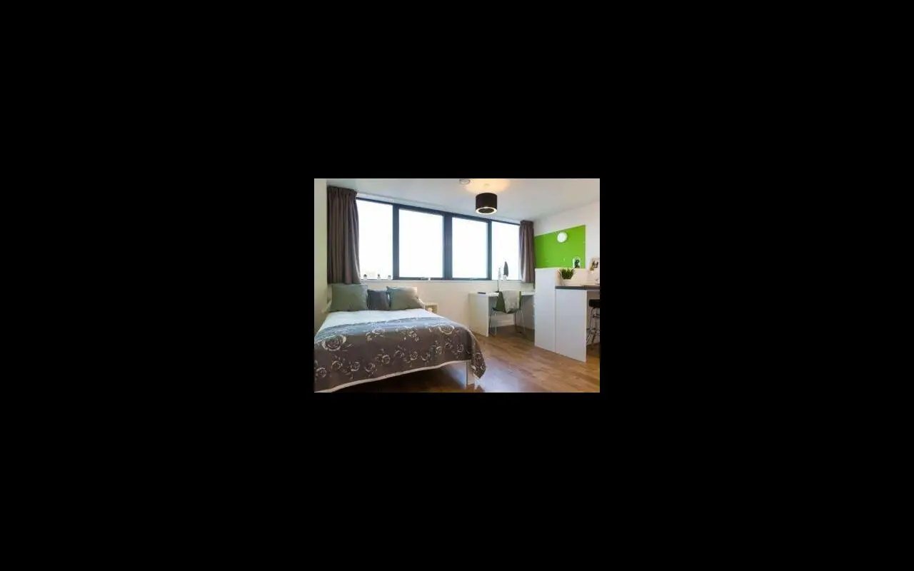 Bed desk and kitchen counter living area at St Lawrence House in Bristol Student Accommodation